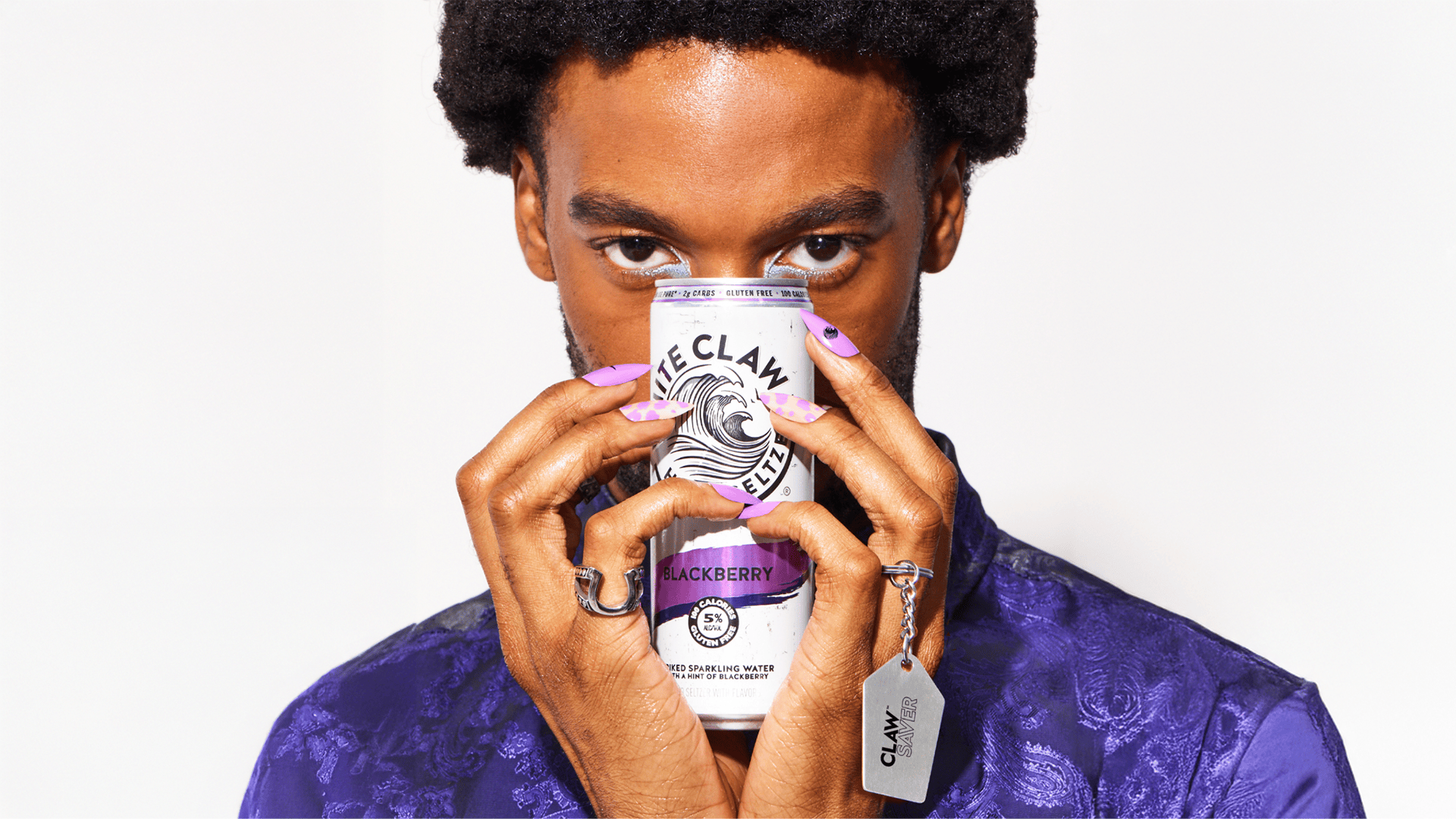 A person holding White Claw tin Blackberry flavor