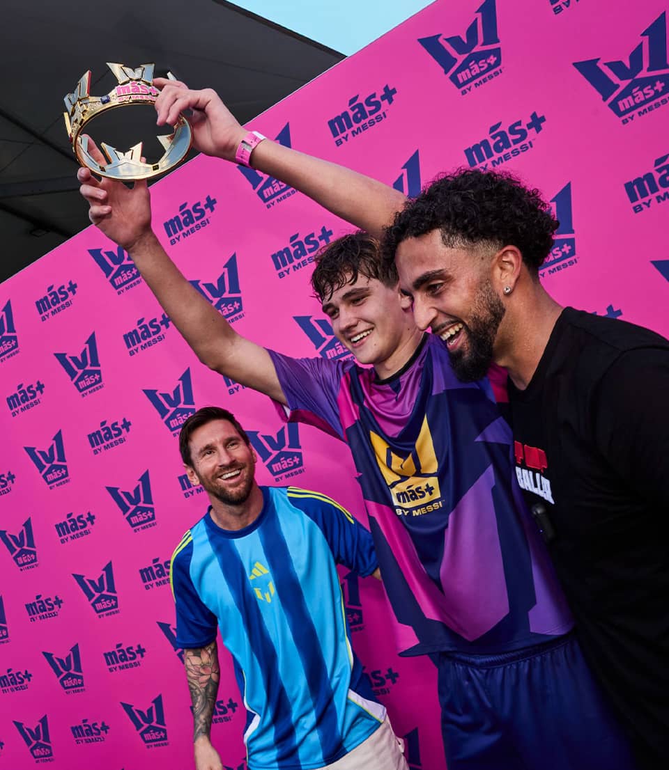 Messi and another men where one is holding 1v1 golden crown above his head
